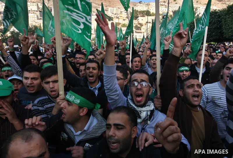 Palestinian supporters of the Islamist movement Hamas shout slogans during a demonstration in the West Bank city of Hebron, 21 November 2012, to show solidarity with Palestinians in the Gaza Strip. Palestinian militants...