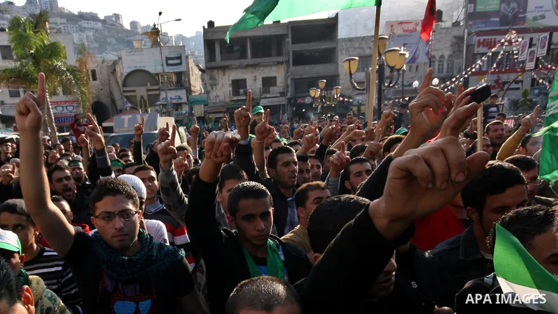 Palestinian supporters of the Islamist movement Hamas shout slogans during a demonstration in the West Bank city of Hebron, 21 November 2012, to show solidarity with Palestinians in the Gaza Strip. Palestinian militants...