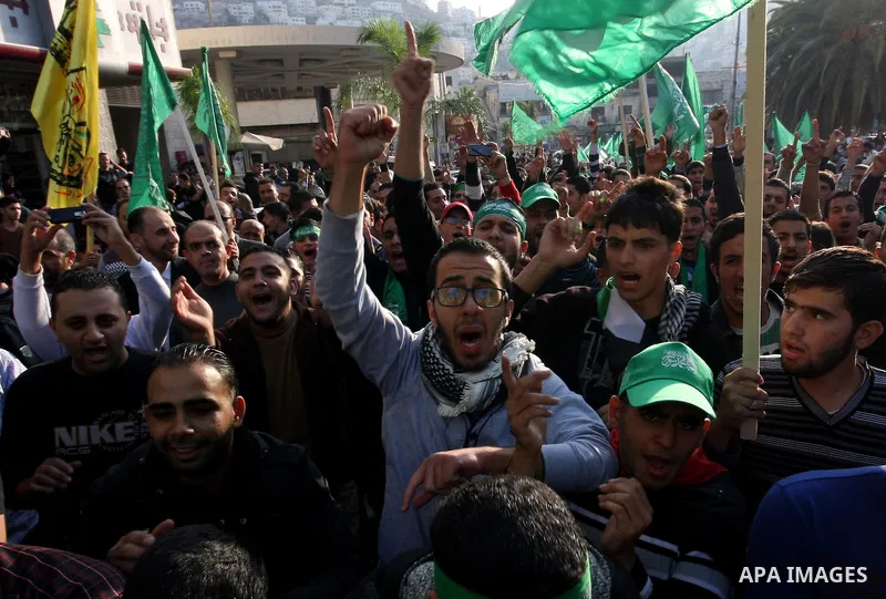 Palestinian supporters of the Islamist movement Hamas shout slogans during a demonstration in the West Bank city of Hebron, 21 November 2012, to show solidarity with Palestinians in the Gaza Strip. Palestinian militants...