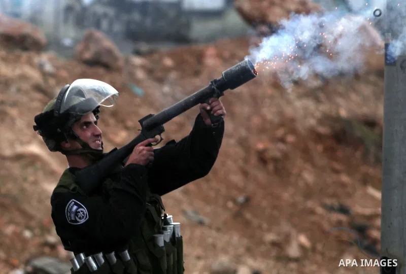 Israeli soldiers fire tear gas towards stone throwers demonstrating against the Israeli military offensive on the Gaza Strip at the Qalandia checkpoint, in the Israeli occupied West Bank, on November 21, 2012 .Israel lau...