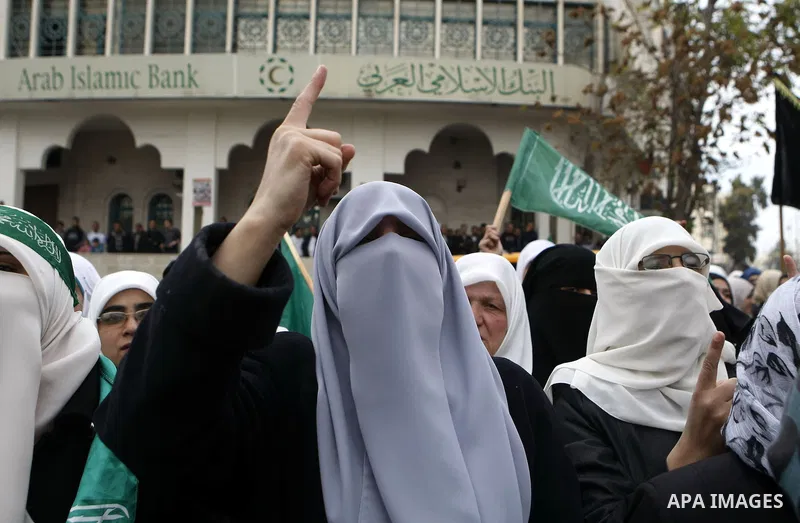 Palestinian supporters of the Islamist movement Hamas shout slogans during a demonstration in the West Bank city of Hebron, 21 November 2012, to show solidarity with Palestinians in the Gaza Strip. Palestinian militants...