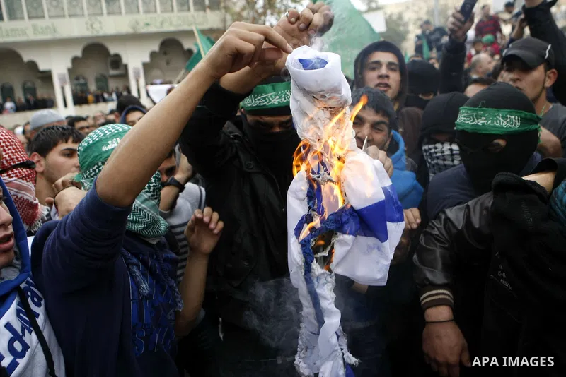 Palestinian supporters of the Islamist movement Hamas shout slogans during a demonstration in the West Bank city of Hebron, 21 November 2012, to show solidarity with Palestinians in the Gaza Strip. Palestinian militants...