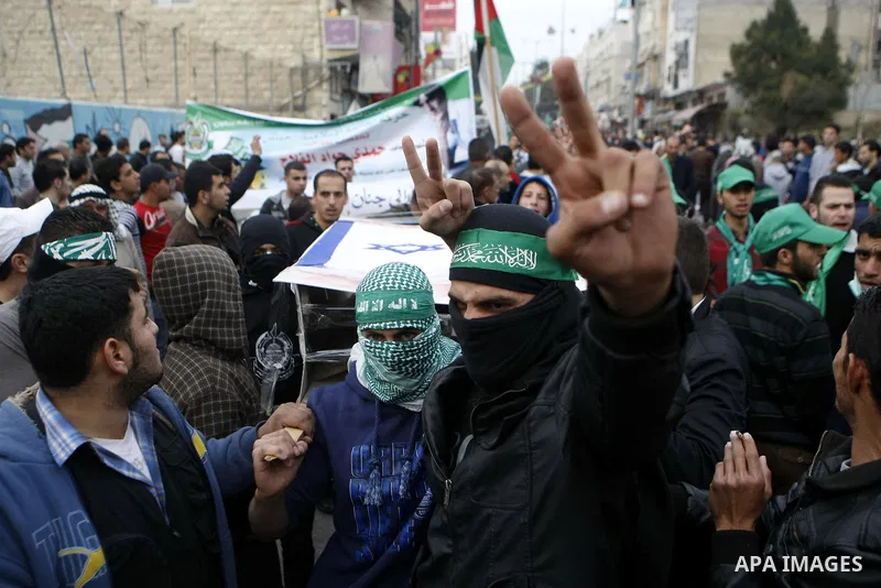 Palestinian supporters of the Islamist movement Hamas shout slogans during a demonstration in the West Bank city of Hebron, 21 November 2012, to show solidarity with Palestinians in the Gaza Strip. Palestinian militants...
