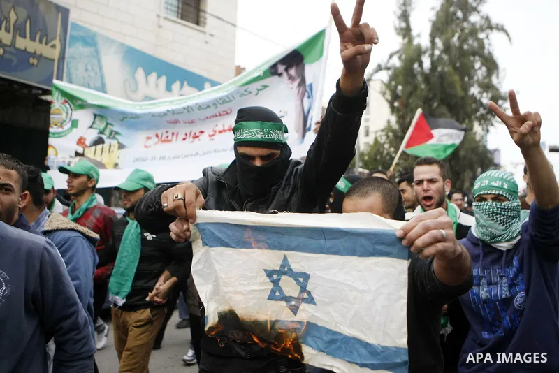 Palestinian supporters of the Islamist movement Hamas shout slogans during a demonstration in the West Bank city of Hebron, 21 November 2012, to show solidarity with Palestinians in the Gaza Strip. Palestinian militants...