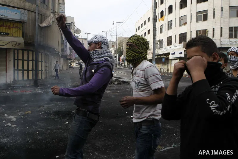 Palestinian stone throwers clash with Israeli border police in the West Bank city of Hebron on November 21, 2012, protesting against the ongoing Israeli military offensive on the Gaza Strip. Israel launched its offensive...