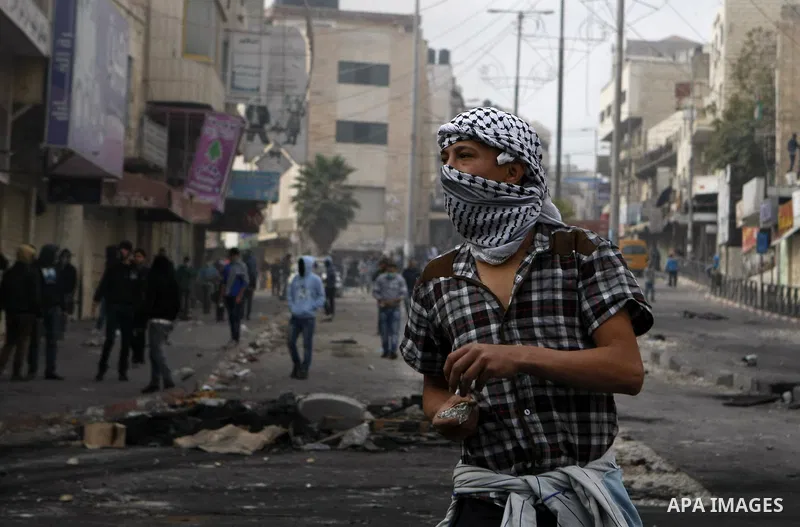 Palestinian stone throwers clash with Israeli border police in the West Bank city of Hebron on November 21, 2012, protesting against the ongoing Israeli military offensive on the Gaza Strip. Israel launched its offensive...