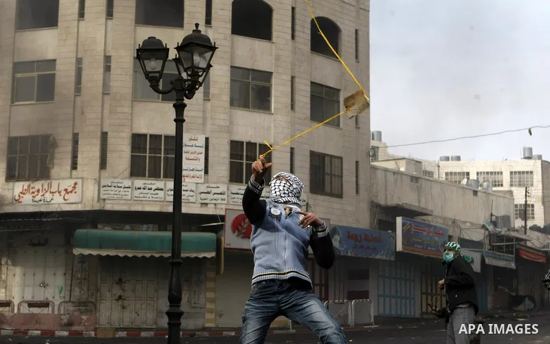 Palestinian stone throwers clash with Israeli border police in the West Bank city of Hebron on November 21, 2012, protesting against the ongoing Israeli military offensive on the Gaza Strip. Israel launched its offensive...