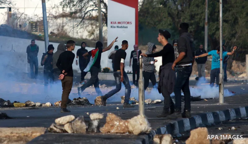 Palestinian protesters throw stones at Israeli soldiers during clashes in the West Bank city of Nablus, on November 21, 2012. The West Bank has witnessed almost daily demonstrations in support of Gaza Palestinians who ha...