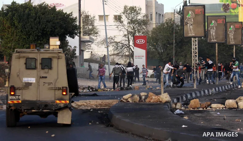 Palestinian protesters throw stones at Israeli soldiers during clashes in the West Bank city of Nablus, on November 21, 2012. The West Bank has witnessed almost daily demonstrations in support of Gaza Palestinians who ha...