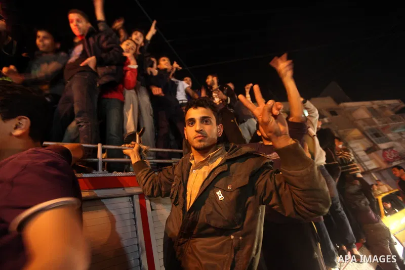 Palestinians celebrate what they say is a victory over Israel after an eight-day conflict in Gaza City, November 21, 2012. Israel and the Islamist Hamas movement agreed on Wednesday to an Egyptian-sponsored ceasefire to...