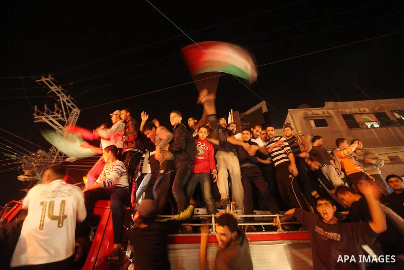 Palestinians celebrate what they say is a victory over Israel after an eight-day conflict in Gaza City, November 21, 2012. Israel and the Islamist Hamas movement agreed on Wednesday to an Egyptian-sponsored ceasefire to...