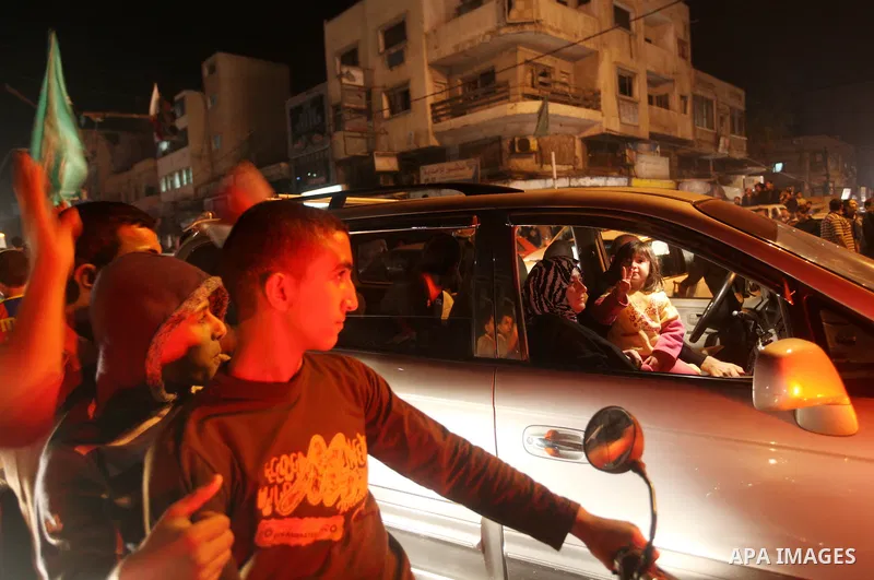 Palestinians celebrate what they say is a victory over Israel after an eight-day conflict in Gaza City, November 21, 2012. Israel and the Islamist Hamas movement agreed on Wednesday to an Egyptian-sponsored ceasefire to...