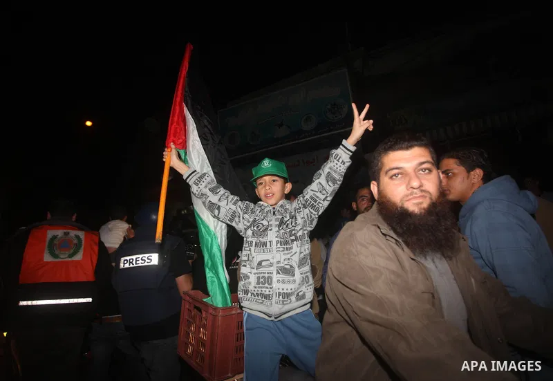 Palestinians celebrate what they say is a victory over Israel after an eight-day conflict in Gaza City, November 21, 2012. Israel and the Islamist Hamas movement agreed on Wednesday to an Egyptian-sponsored ceasefire to...