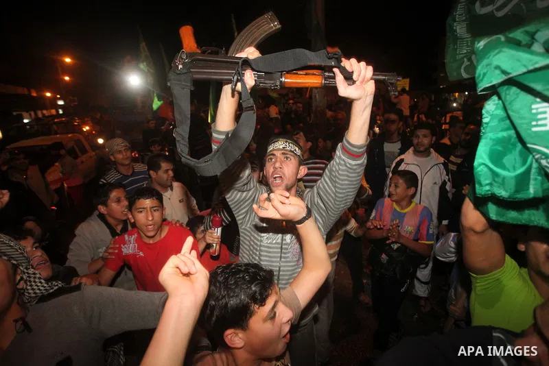 Palestinians celebrate what they say is a victory over Israel after an eight-day conflict in Gaza City, November 21, 2012. Israel and the Islamist Hamas movement agreed on Wednesday to an Egyptian-sponsored ceasefire to...