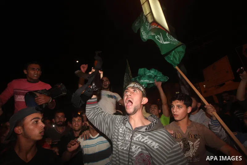 Palestinians celebrate what they say is a victory over Israel after an eight-day conflict in Gaza City, November 21, 2012. Israel and the Islamist Hamas movement agreed on Wednesday to an Egyptian-sponsored ceasefire to...