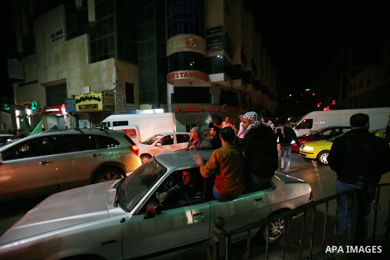 Palestinians celebrate what they say is a victory over Israel after an eight-day conflict, in the West Bank city of Hebron, November 21, 2012. Israel and the Islamist Hamas movement agreed on Wednesday to an Egyptian-spo...