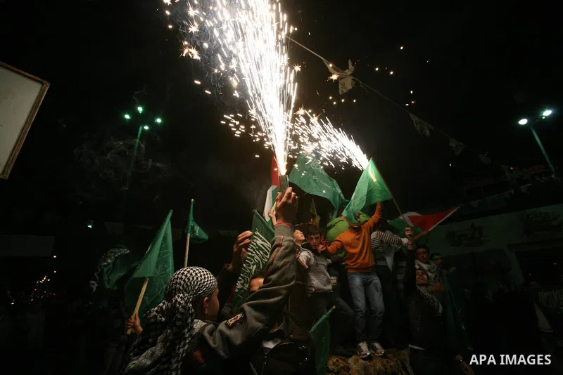 Palestinians celebrate what they say is a victory over Israel after an eight-day conflict, in the West Bank city of Hebron, November 21, 2012. Israel and the Islamist Hamas movement agreed on Wednesday to an Egyptian-spo...