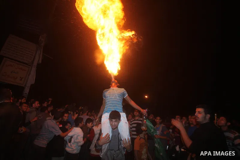 Palestinians celebrate what they say is a victory over Israel after an eight-day conflict in Gaza City, November 21, 2012. Israel and the Islamist Hamas movement agreed on Wednesday to an Egyptian-sponsored ceasefire to...