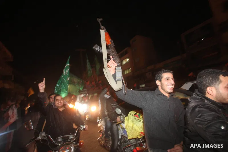 Palestinians celebrate what they say is a victory over Israel after an eight-day conflict in Gaza City, November 21, 2012. Israel and the Islamist Hamas movement agreed on Wednesday to an Egyptian-sponsored ceasefire to...