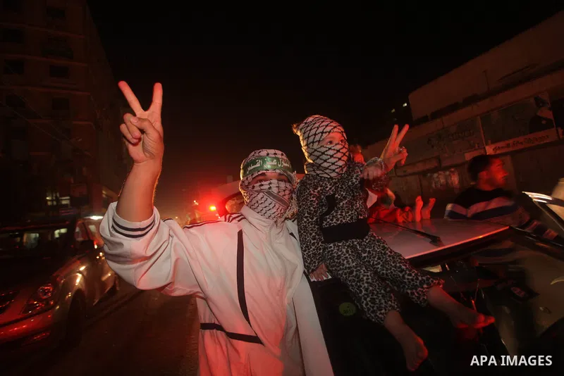 Palestinians celebrate what they say is a victory over Israel after an eight-day conflict in Gaza City, November 21, 2012. Israel and the Islamist Hamas movement agreed on Wednesday to an Egyptian-sponsored ceasefire to...