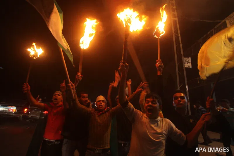 Palestinians celebrate what they say is a victory over Israel after an eight-day conflict in Gaza City, November 21, 2012. Israel and the Islamist Hamas movement agreed on Wednesday to an Egyptian-sponsored ceasefire to...