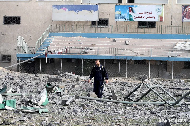 Palestinians inspect the debris of the destroyed Palestine Sports Stadium in Gaza City on November 22, 2012, after a ceasefire took hold in and around Gaza after a week of cross-border violence between Israel and Palesti...