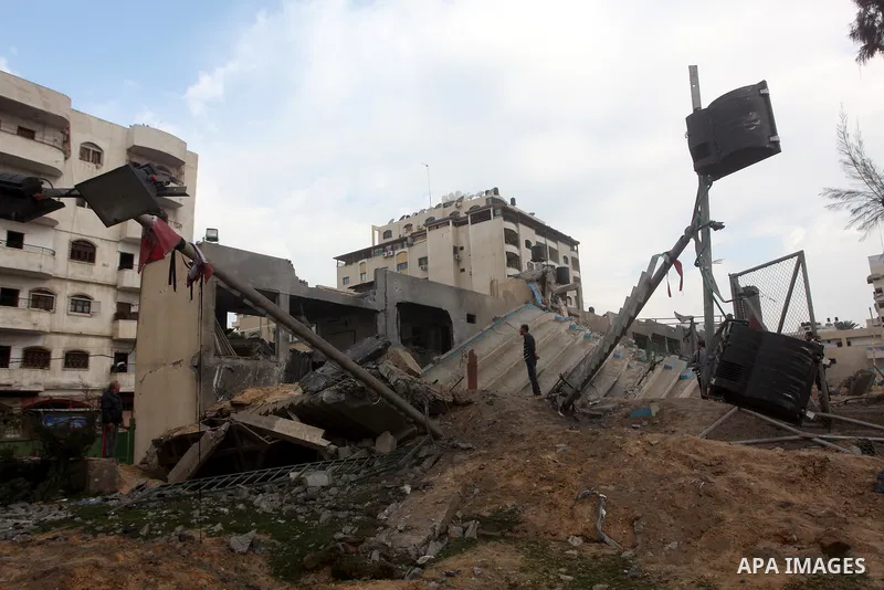 Palestinians inspect the debris of the destroyed Palestine Sports Stadium in Gaza City on November 22, 2012, after a ceasefire took hold in and around Gaza after a week of cross-border violence between Israel and Palesti...