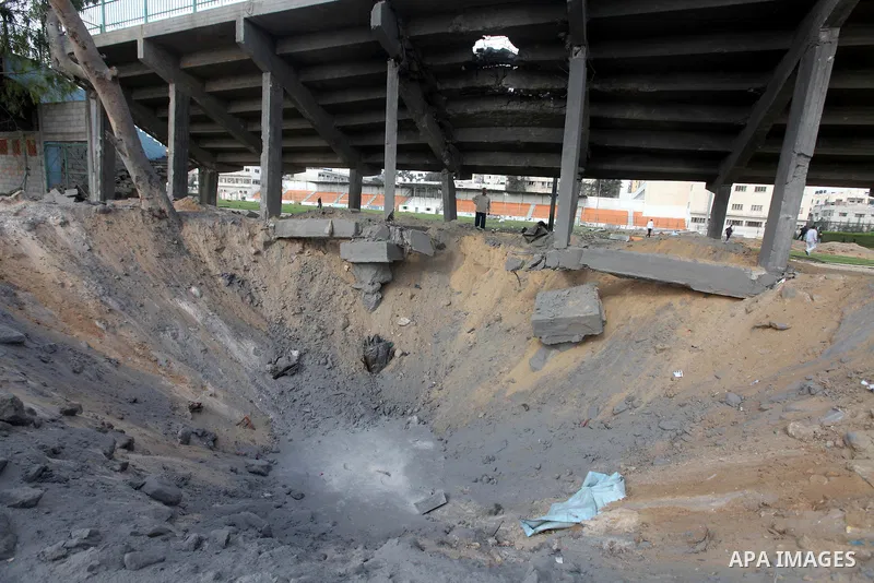 Palestinians inspect the debris of the destroyed Yarmouk Sports Stadium in Gaza City on November 22, 2012, after a ceasefire took hold in and around Gaza after a week of cross-border violence between Israel and Palestini...