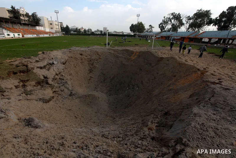 Palestinians inspect the debris of the destroyed Yarmouk Sports Stadium in Gaza City on November 22, 2012, after a ceasefire took hold in and around Gaza after a week of cross-border violence between Israel and Palestini...