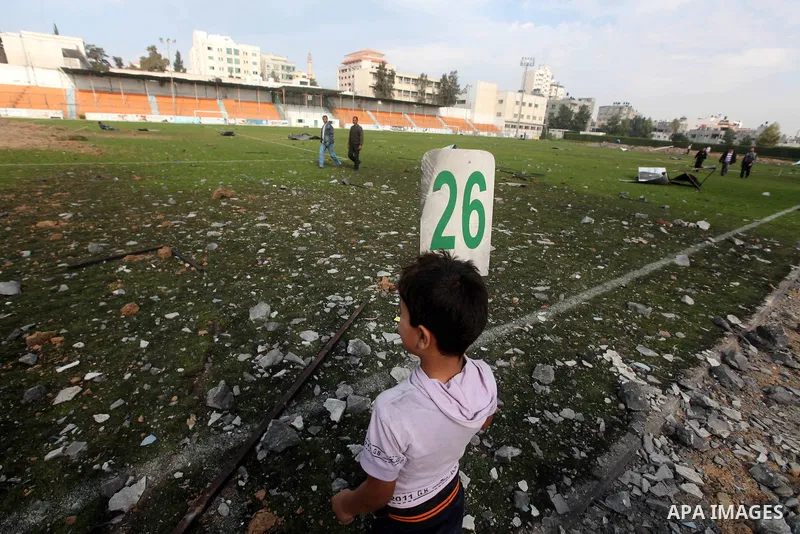 Palestinians inspect the debris of the destroyed Yarmouk Sports Stadium in Gaza City on November 22, 2012, after a ceasefire took hold in and around Gaza after a week of cross-border violence between Israel and Palestini...