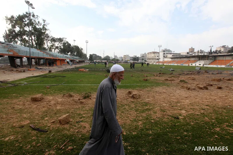 Palestinians inspect the debris of the destroyed Yarmouk Sports Stadium in Gaza City on November 22, 2012, after a ceasefire took hold in and around Gaza after a week of cross-border violence between Israel and Palestini...