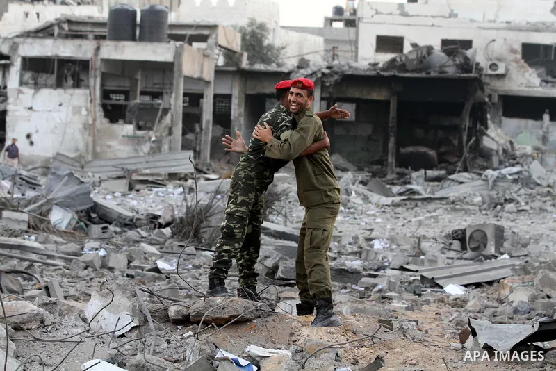 Hamas police officers embrace after their return to their destroyed Al-Saraya headquarters in Gaza City November 22, 2012, a day after a cease fire was declared between Israel and Hamas. An Egypt-brokered truce took hold...