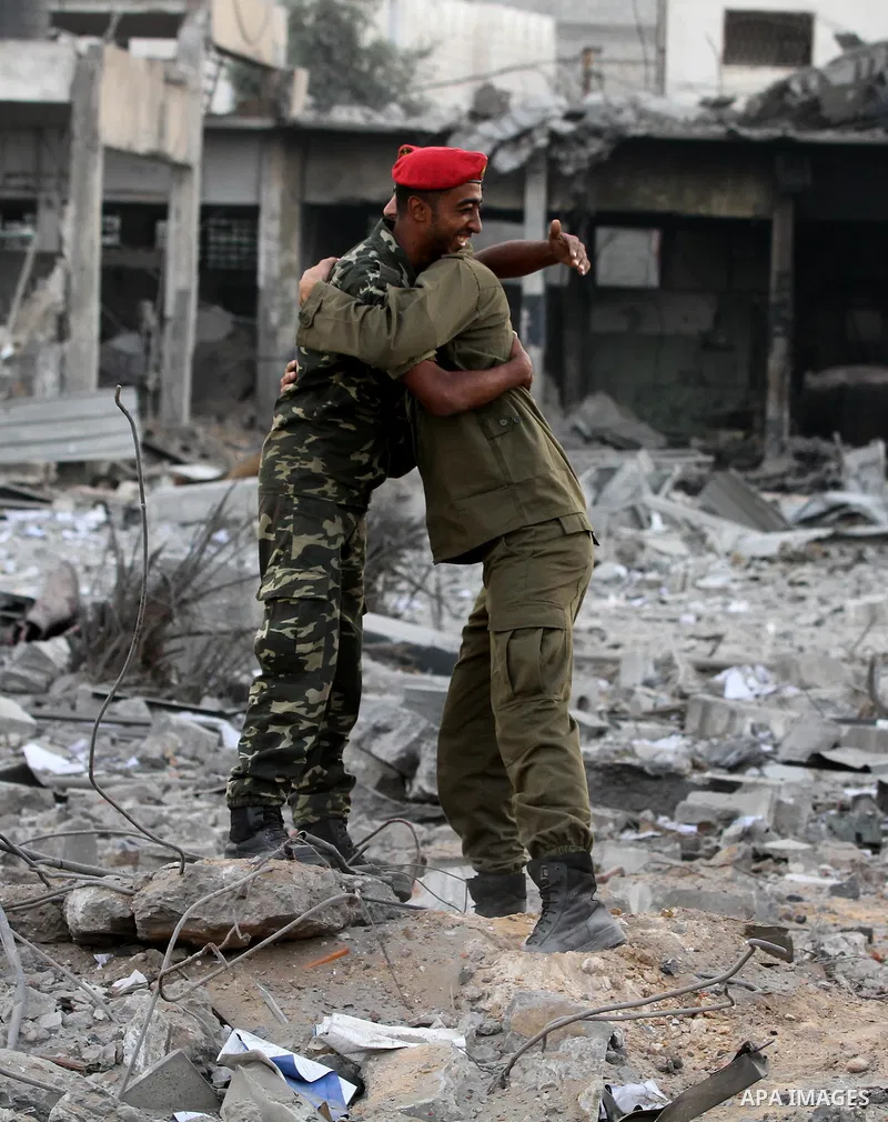 Hamas police officers embrace after their return to their destroyed Al-Saraya headquarters in Gaza City November 22, 2012, a day after a cease fire was declared between Israel and Hamas. An Egypt-brokered truce took hold...