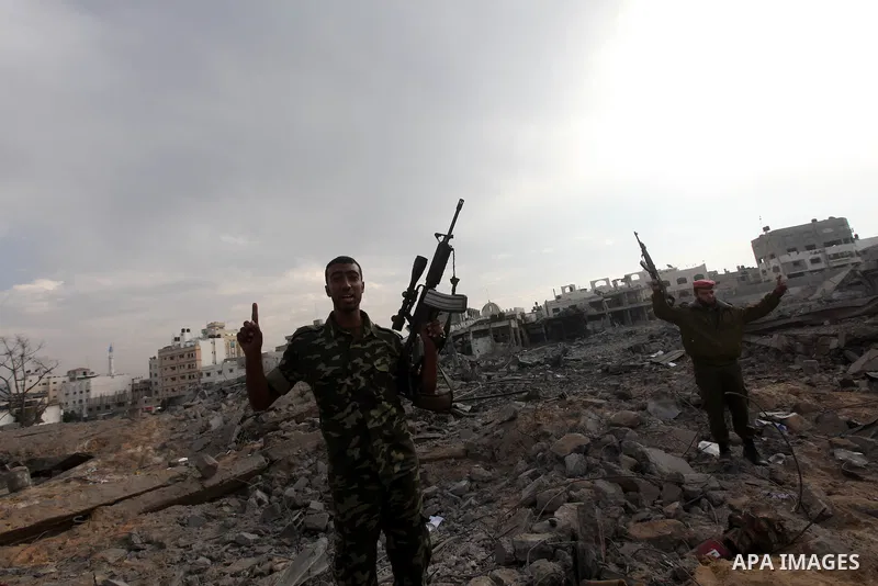 Hamas police officers embrace after their return to their destroyed Al-Saraya headquarters in Gaza City November 22, 2012, a day after a cease fire was declared between Israel and Hamas. An Egypt-brokered truce took hold...