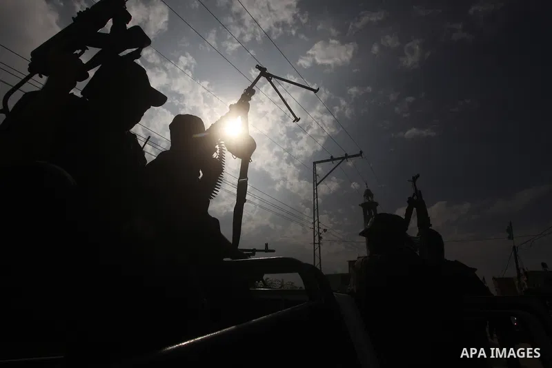 Hamas militants ride in a pick-up truck as they take part in the funeral of their comrades, whom medics said were killed in Israeli air strikes on Wednesday, in the central Gaza Strip November 22, 2012. A ceasefire betwe...