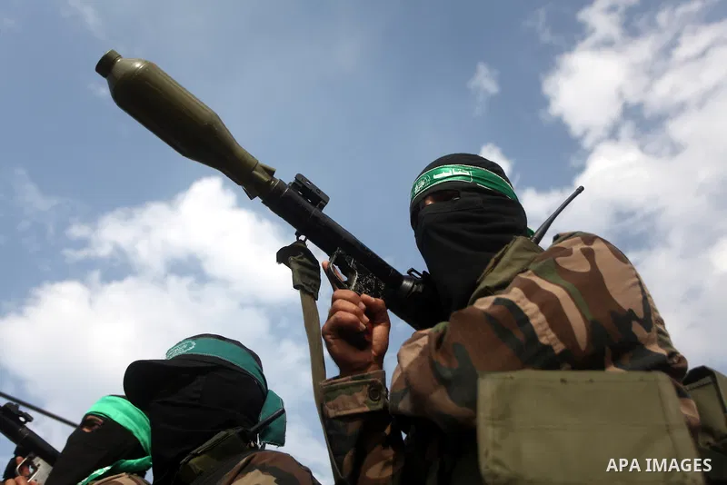 Hamas militants ride in a pick-up truck as they take part in the funeral of their comrades, whom medics said were killed in Israeli air strikes on Wednesday, in the central Gaza Strip November 22, 2012. A ceasefire betwe...