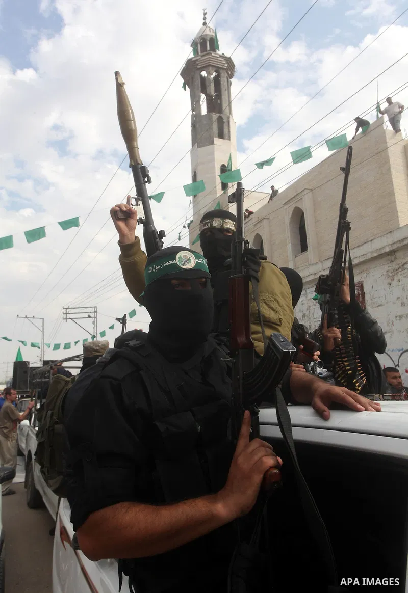 Hamas militants ride in a pick-up truck as they take part in the funeral of their comrades, whom medics said were killed in Israeli air strikes on Wednesday, in the central Gaza Strip November 22, 2012. A ceasefire betwe...