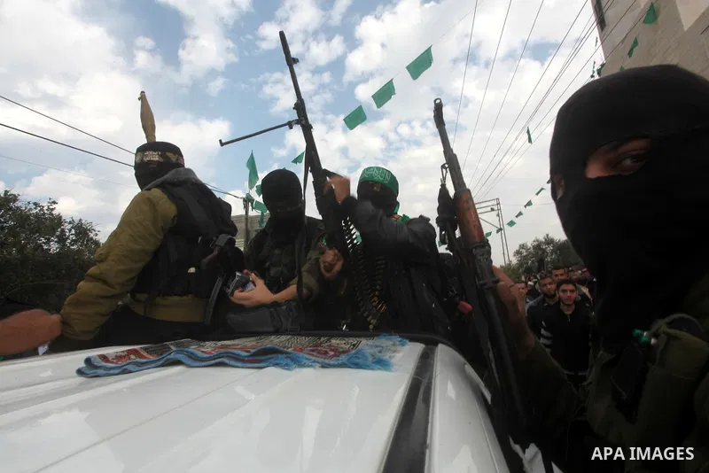Hamas militants ride in a pick-up truck as they take part in the funeral of their comrades, whom medics said were killed in Israeli air strikes on Wednesday, in the central Gaza Strip November 22, 2012. A ceasefire betwe...