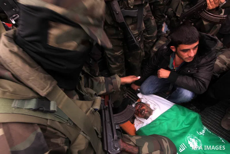 Hamas militants carry the body of a fellow comrade, whom medics said was killed in an Israeli air strike on Wednesday, during his funeral in the central Gaza Strip November 22, 2012. A ceasefire between Israel and Gaza's...