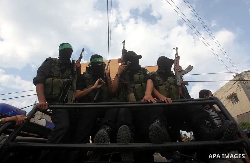 Hamas militants ride in a pick-up truck as they take part in the funeral of their comrades, whom medics said were killed in Israeli air strikes on Wednesday, in the central Gaza Strip November 22, 2012. A ceasefire betwe...