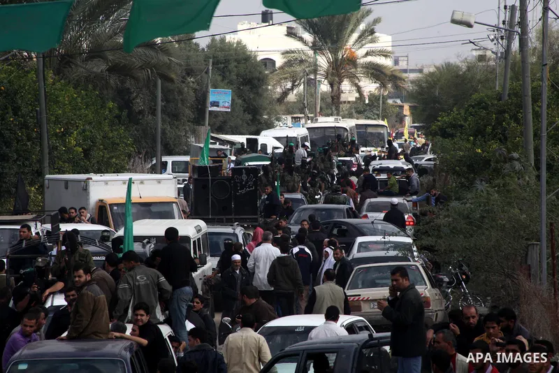 Hamas militants ride in a pick-up truck as they take part in the funeral of their comrades, whom medics said were killed in Israeli air strikes on Wednesday, in the central Gaza Strip November 22, 2012. A ceasefire betwe...