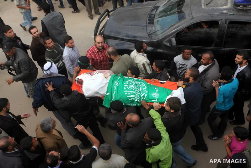 Hamas militants carry the body of a fellow comrade, whom medics said was killed in an Israeli air strike on Wednesday, during his funeral in the central Gaza Strip November 22, 2012. A ceasefire between Israel and Gaza's...