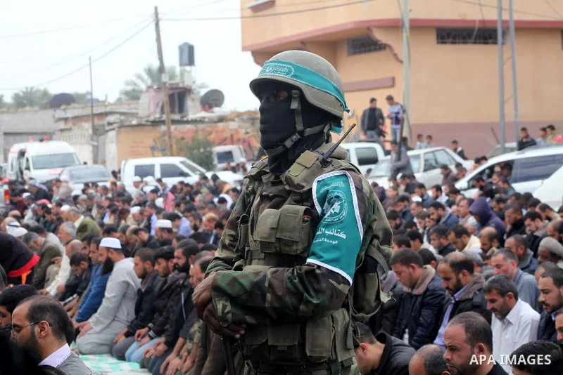 A Hamas militant prayer during the funeral for his fellow comrades, whom medics said were killed in Israeli air strikes on Wednesday, in the central Gaza Strip November 22, 2012. A ceasefire between Israel and Gaza's Ham...