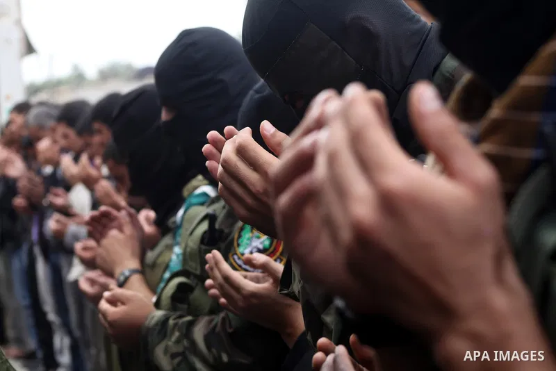 Members of the Ezzedine al-Qassam brigades, the armed wing of Hamas, carry their weapons as they celebrate after the truce between Gaza and Israel came into effect, in the Nusseirat refugee camp in the central Gaza Strip...