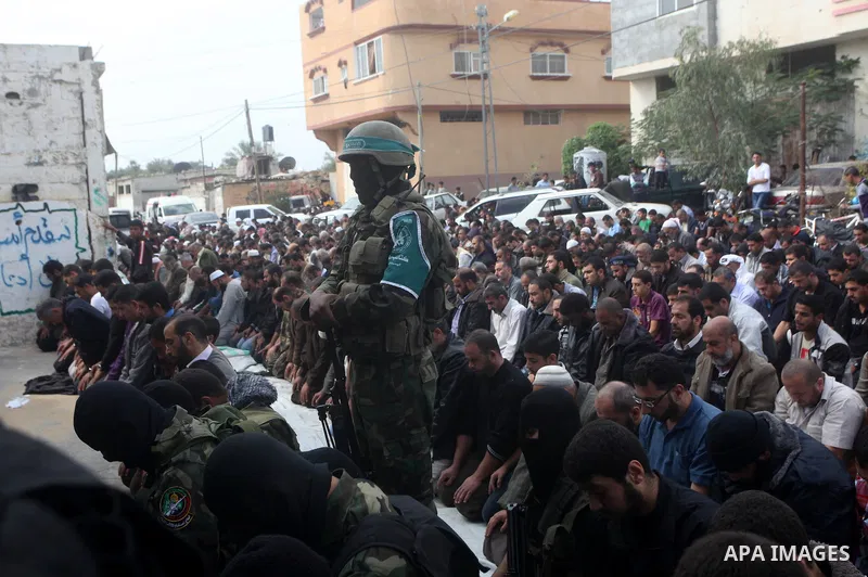 A Hamas militant prayer during the funeral for his fellow comrades, whom medics said were killed in Israeli air strikes on Wednesday, in the central Gaza Strip November 22, 2012. A ceasefire between Israel and Gaza's Ham...