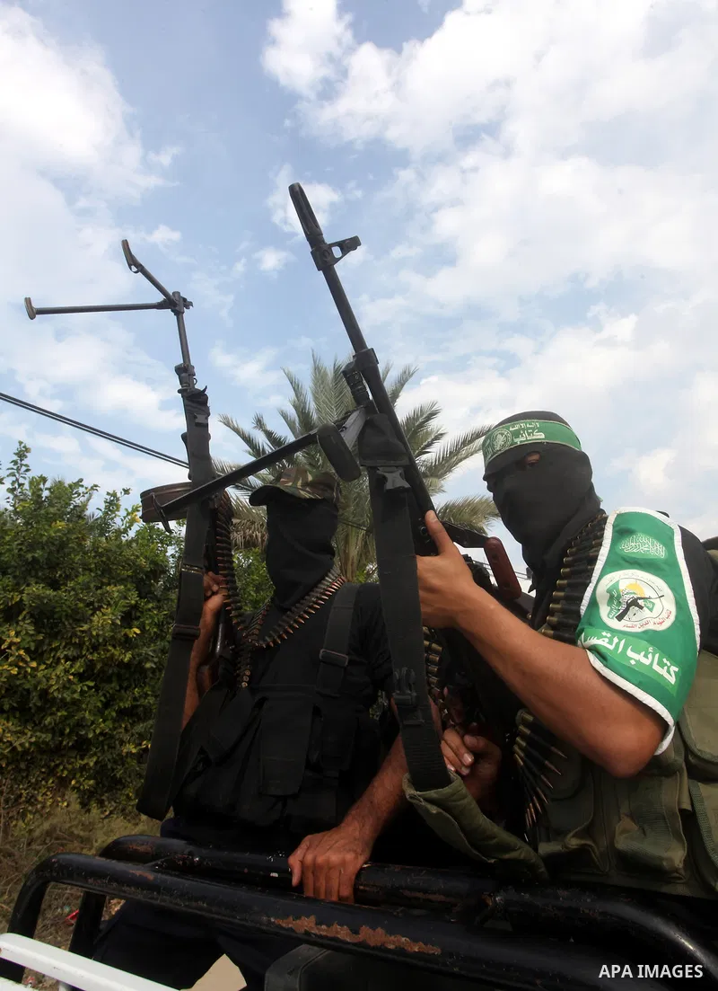 Hamas militants ride in a pick-up truck as they take part in the funeral of their comrades, whom medics said were killed in Israeli air strikes on Wednesday, in the central Gaza Strip November 22, 2012. A ceasefire betwe...