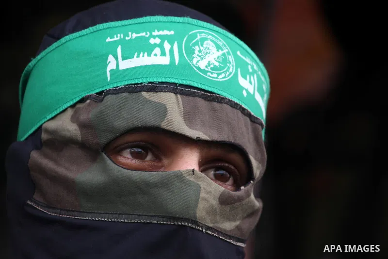 Members of the Ezzedine al-Qassam brigades, the armed wing of Hamas, carry their weapons as they celebrate after the truce between Gaza and Israel came into effect, in the Nusseirat refugee camp in the central Gaza Strip...