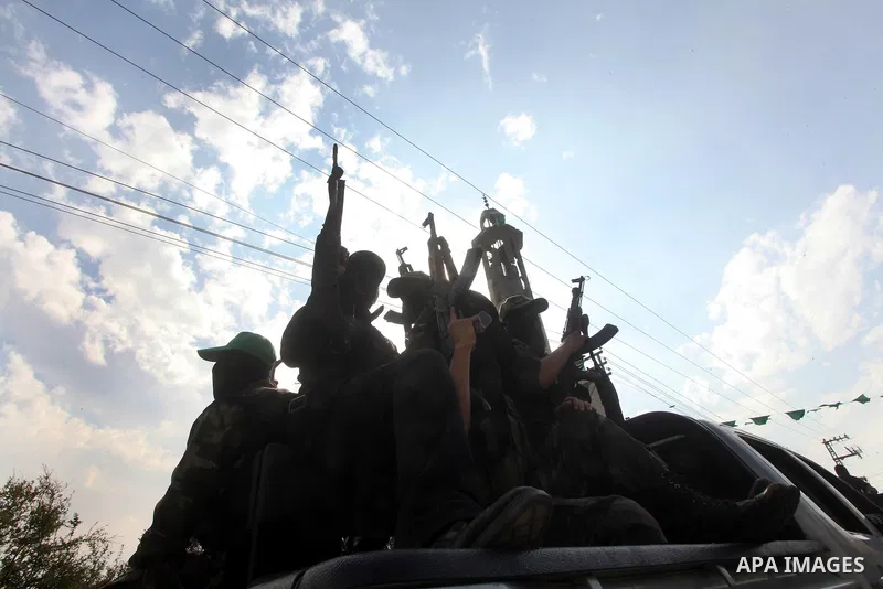 Hamas militants ride in a pick-up truck as they take part in the funeral of their comrades, whom medics said were killed in Israeli air strikes on Wednesday, in the central Gaza Strip November 22, 2012. A ceasefire betwe...