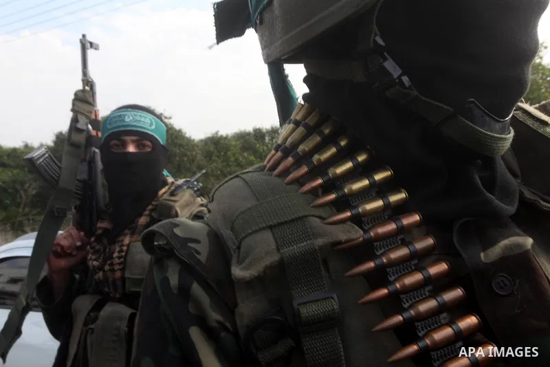 Members of the Ezzedine al-Qassam brigades, the armed wing of Hamas, carry their weapons as they celebrate after the truce between Gaza and Israel came into effect, in the Nusseirat refugee camp in the central Gaza Strip...