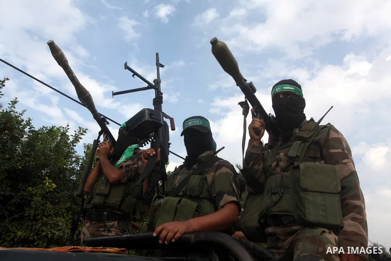 Hamas militants ride in a pick-up truck as they take part in the funeral of their comrades, whom medics said were killed in Israeli air strikes on Wednesday, in the central Gaza Strip November 22, 2012. A ceasefire betwe...